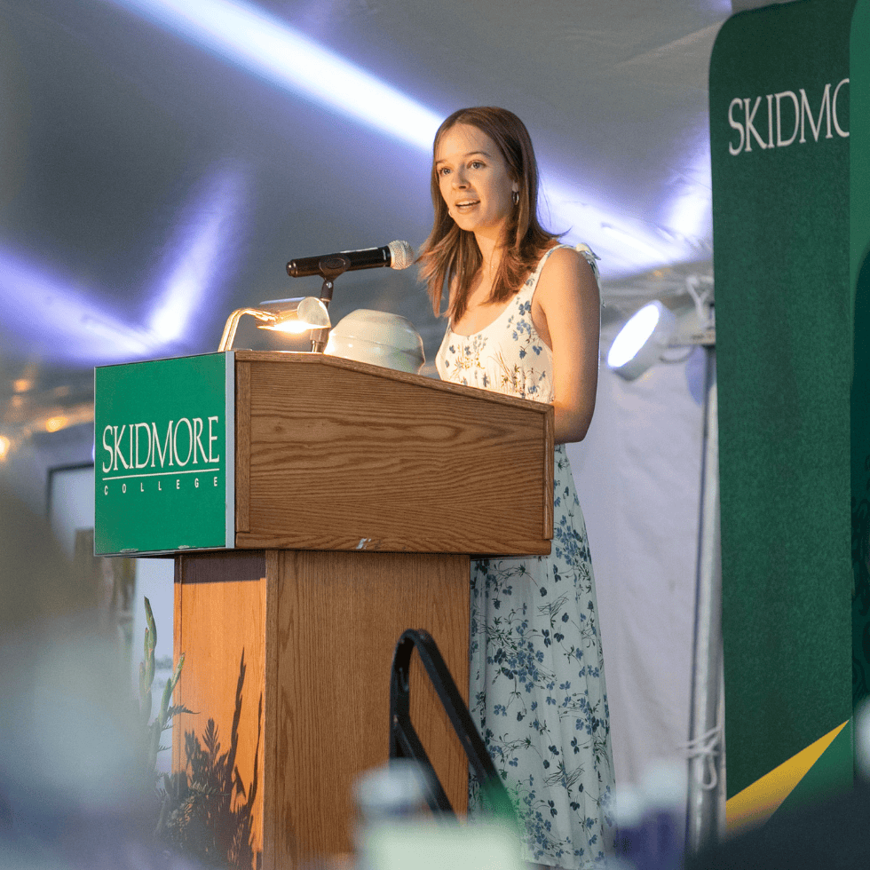 Palamountain scholar speaks at podium during Palamountain Scholarship Benefit.
