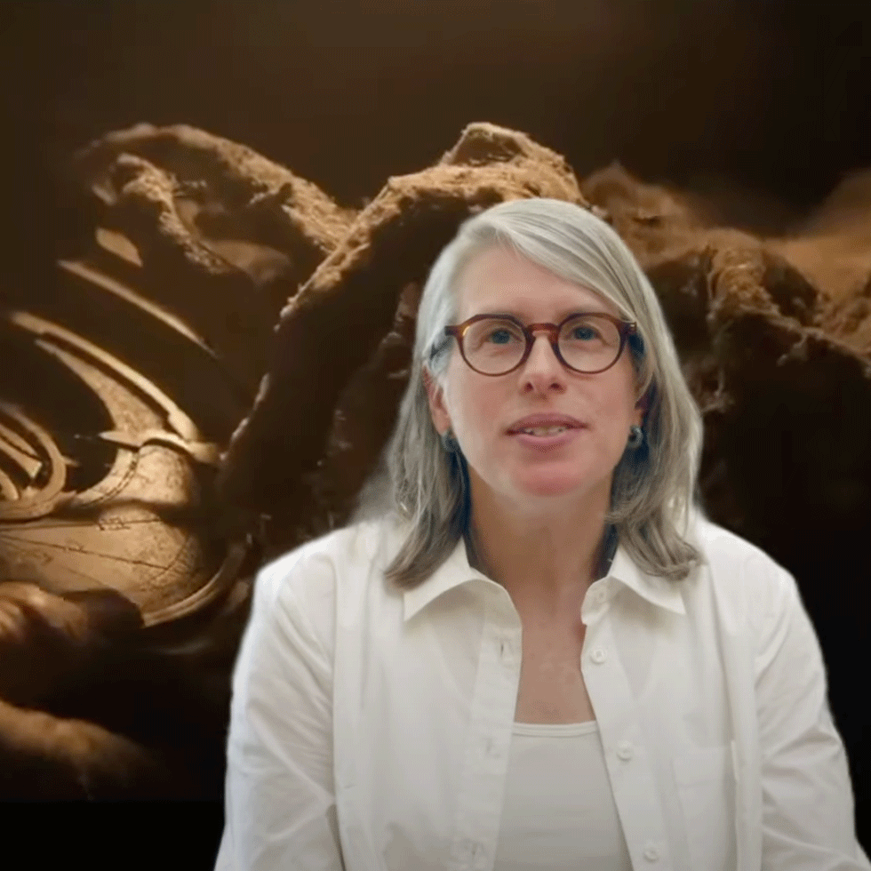 Professor Heather Hurst with a scene from "Indiana Jones: Legends of the Hidden Temple" in the background