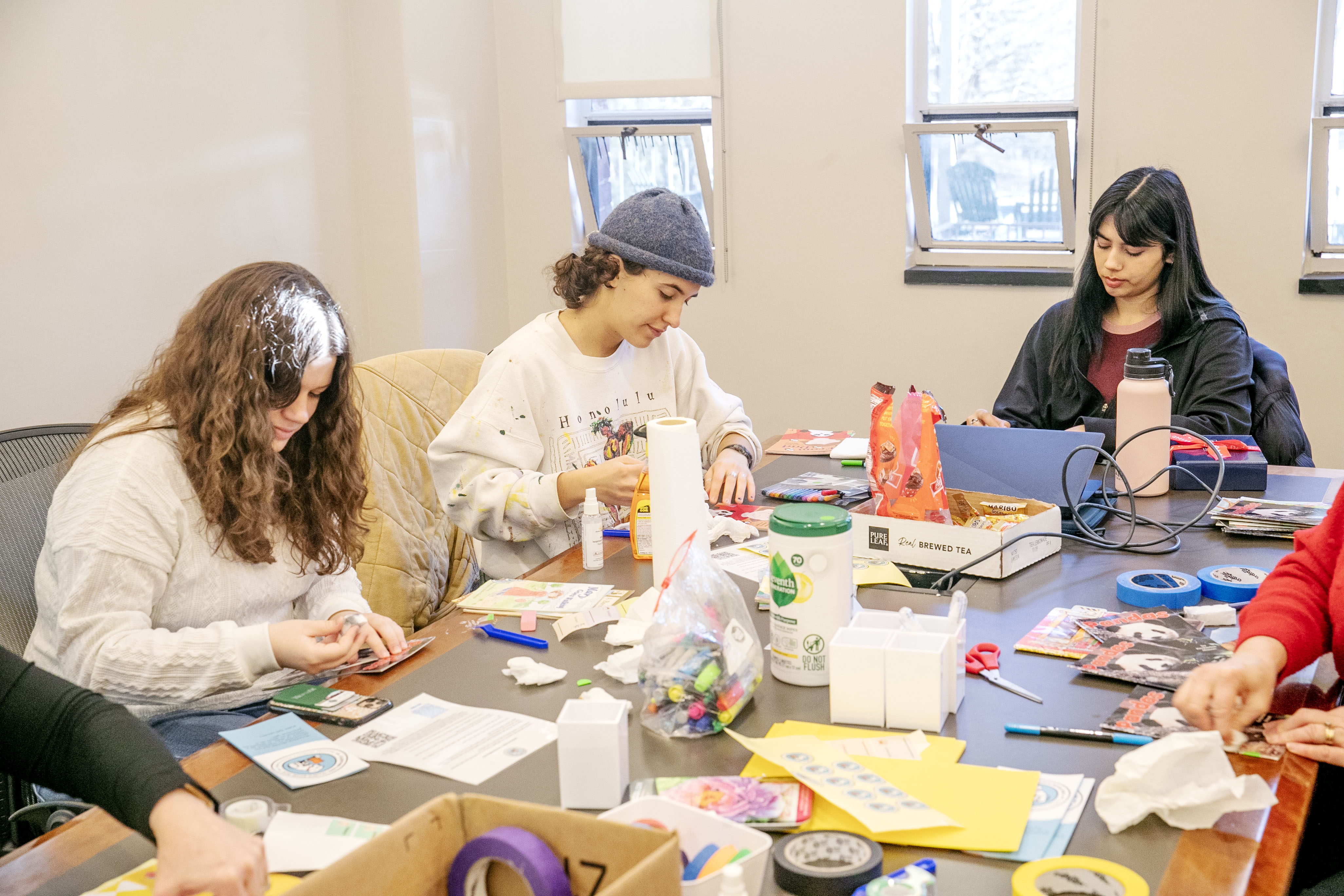 Students repairing children's books for volunteer service