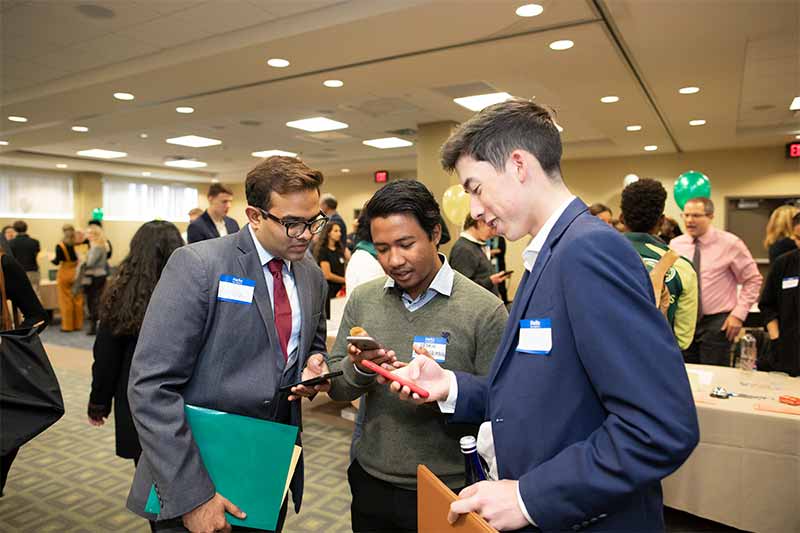 Three Skidmore students looking conversing at a Career Jam event