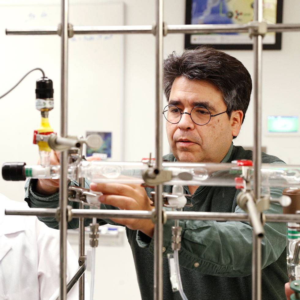 Chemistry Professor Juan Navea works in a research lab. 