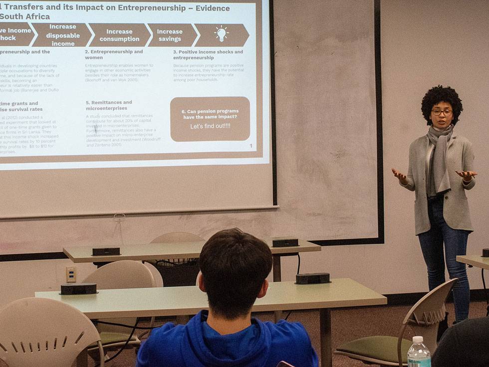 Naira Abdula '20, presents a preliminary draft of her thesis work to her peers in a classroom.