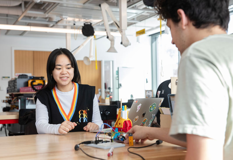 Two students in a creator lab working on an electronics projects
