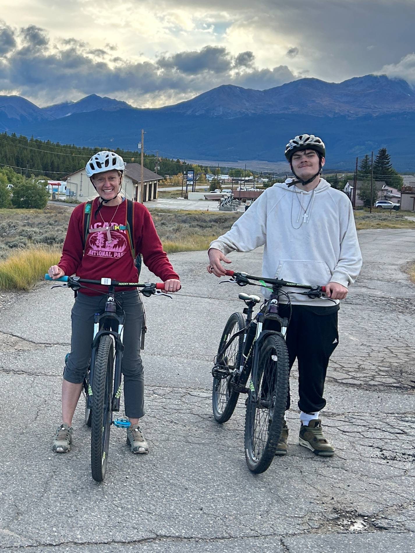 Danika Robison ’10 poses on a bike beside a student in Leadville, Colorado 