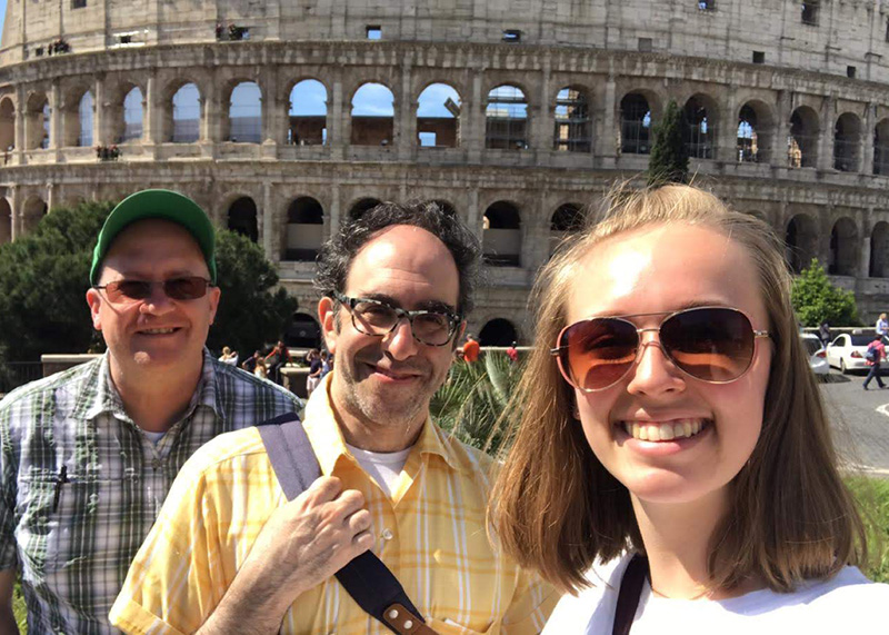 Emily Gunter takes a selfie in front of the Colosseum with Teaching Professor of Religious Studies Greg Spinner and Professor and Chair of Classics Dan Curley.