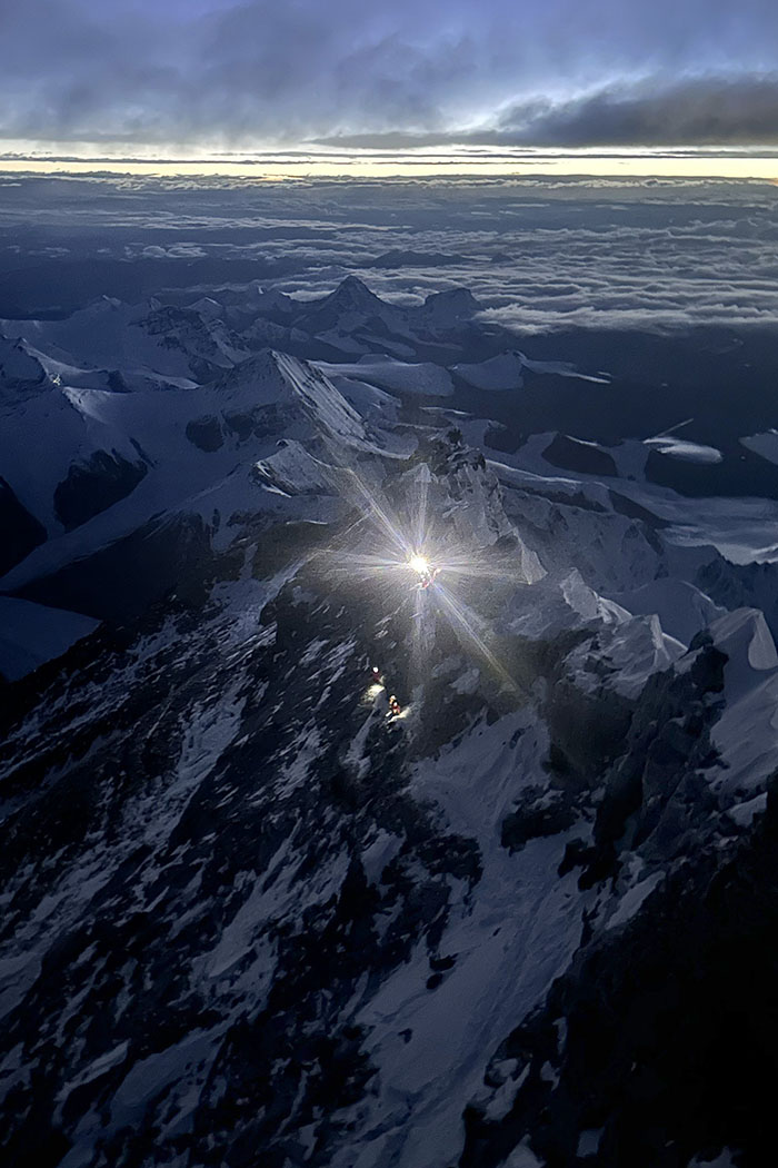 Headlamps from Matt Ferrari’s team of climbers and guides illuminate the way as they make their pre-dawn push toward the summit.