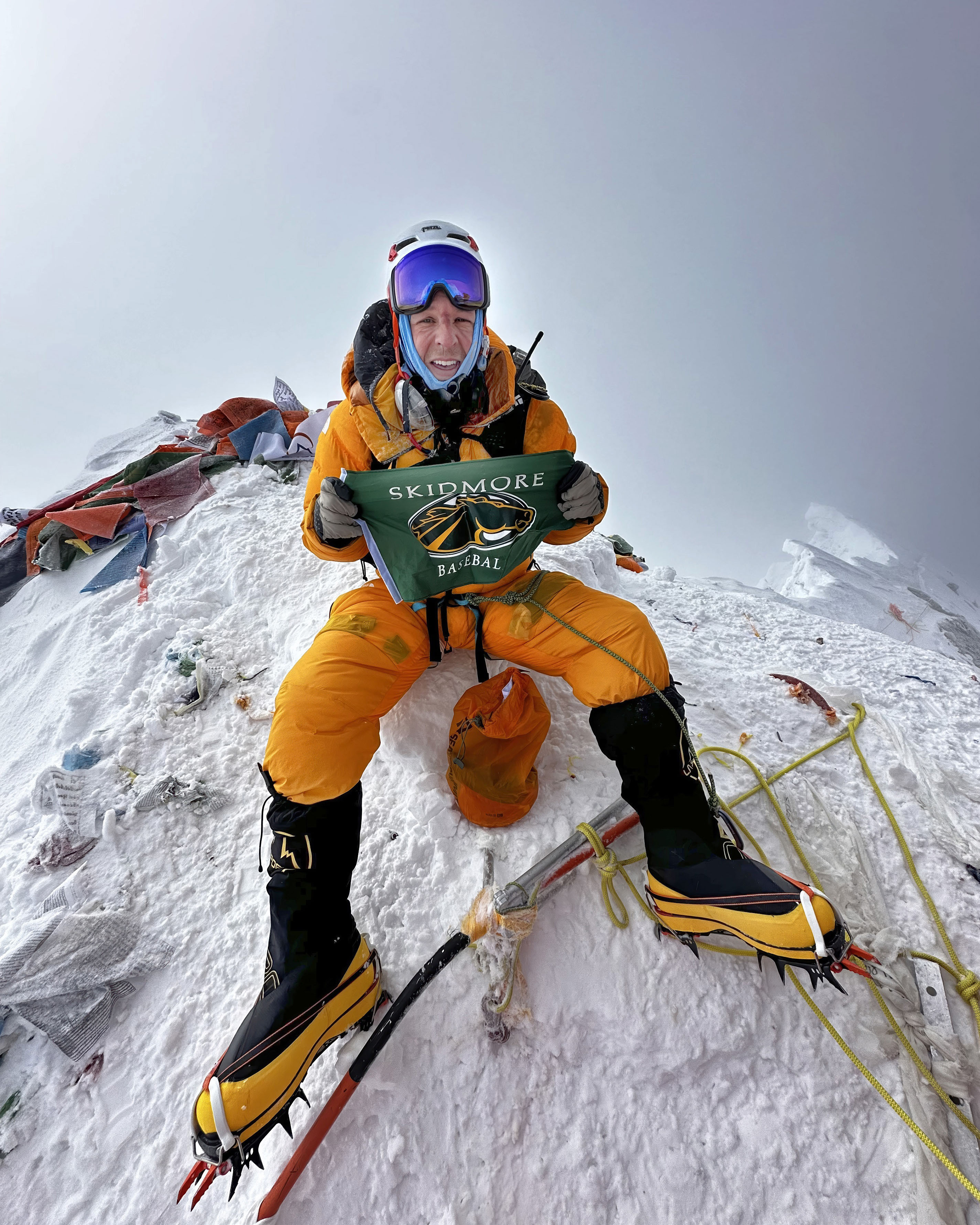 Matt Ferrari ’05 with a Skidmore baseball flag atop Mount Everest
