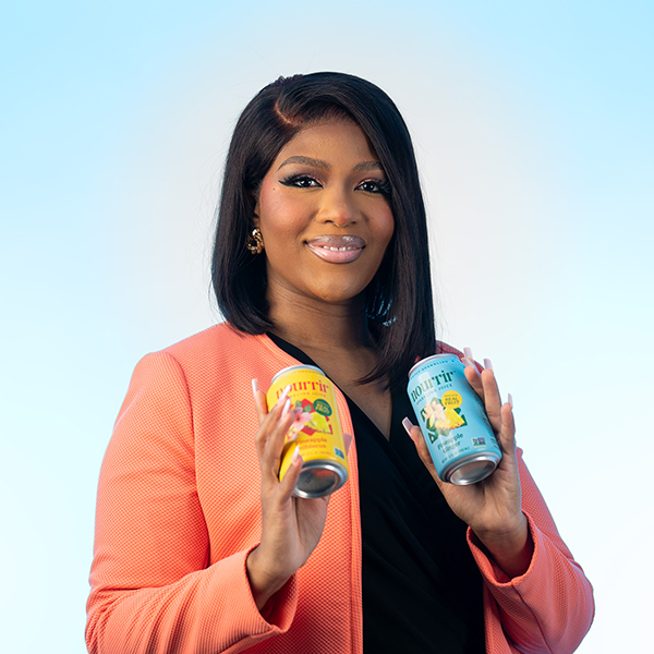 Ivy Asamoah ’19 holding cans of Nourrir Drinks