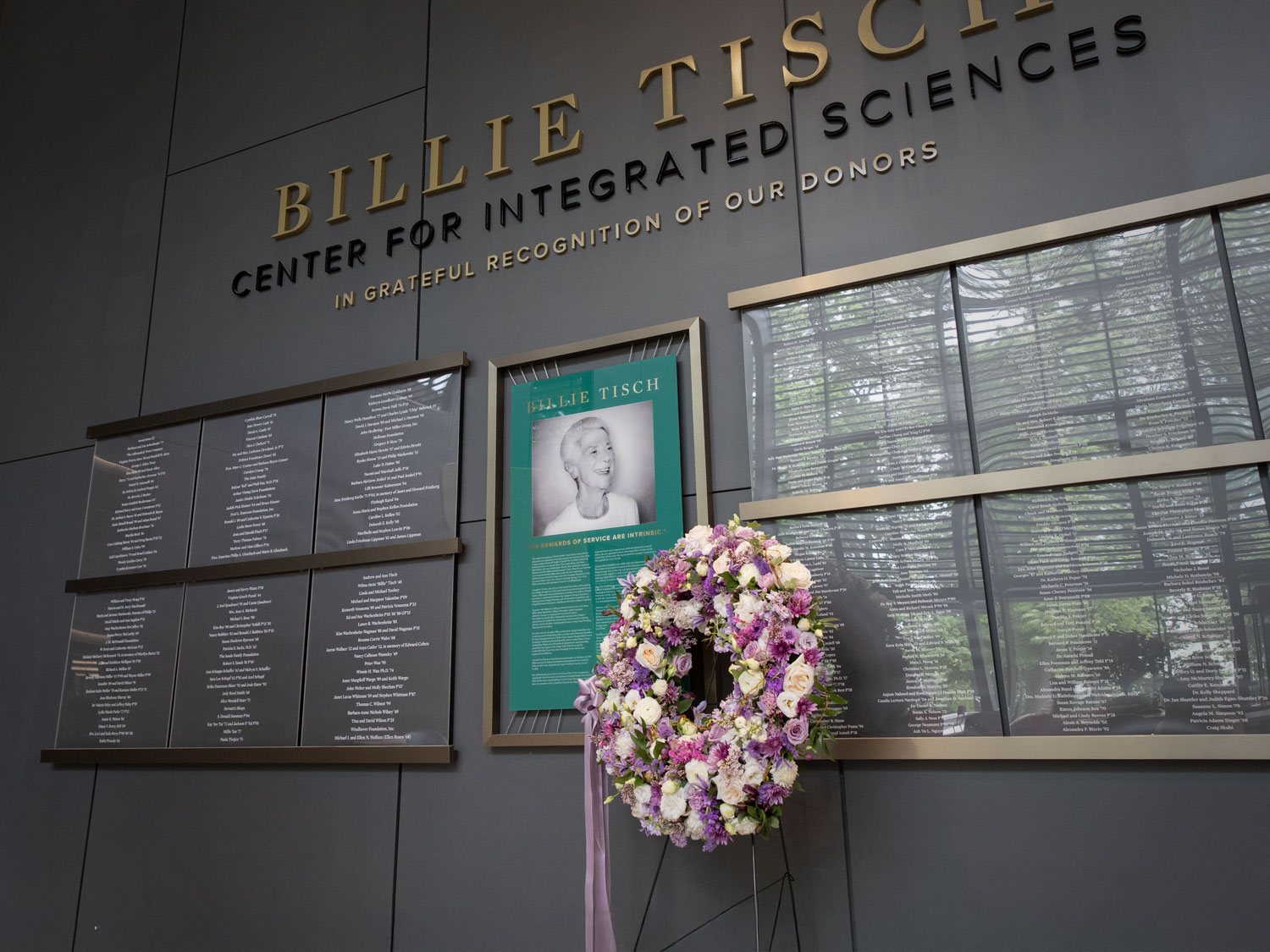 A wreath from the Skidmore community in memory of Billie Tisch '48 lies in the atrium of the Billie Tisch Center for Integrated Sciences at Skidmore College.