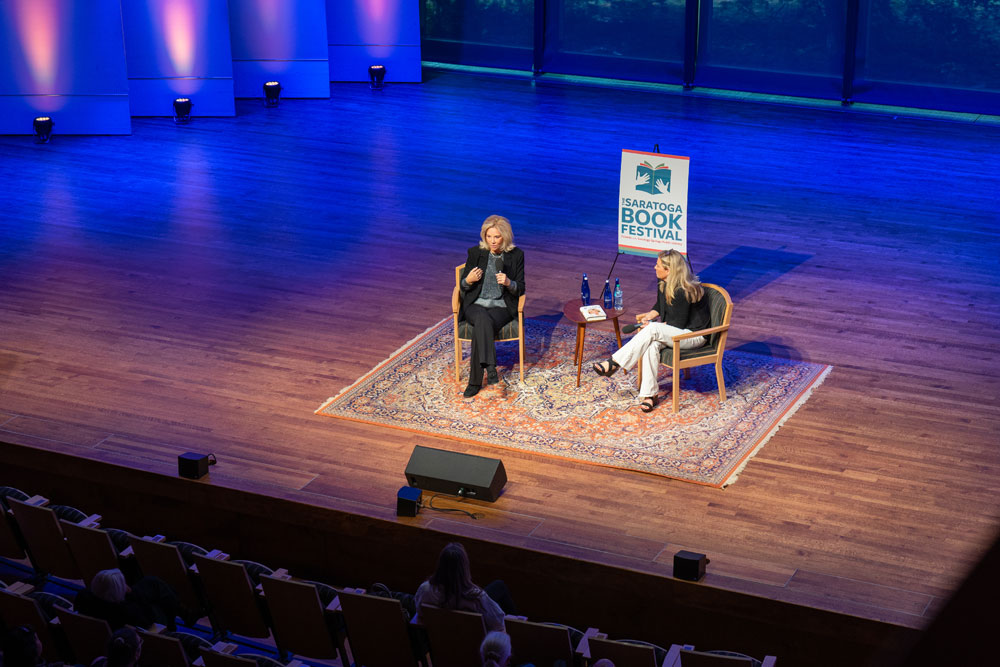 Joan Lunden and Julie Chapman talk while sitting on stage at Arthur Zankel Music Center