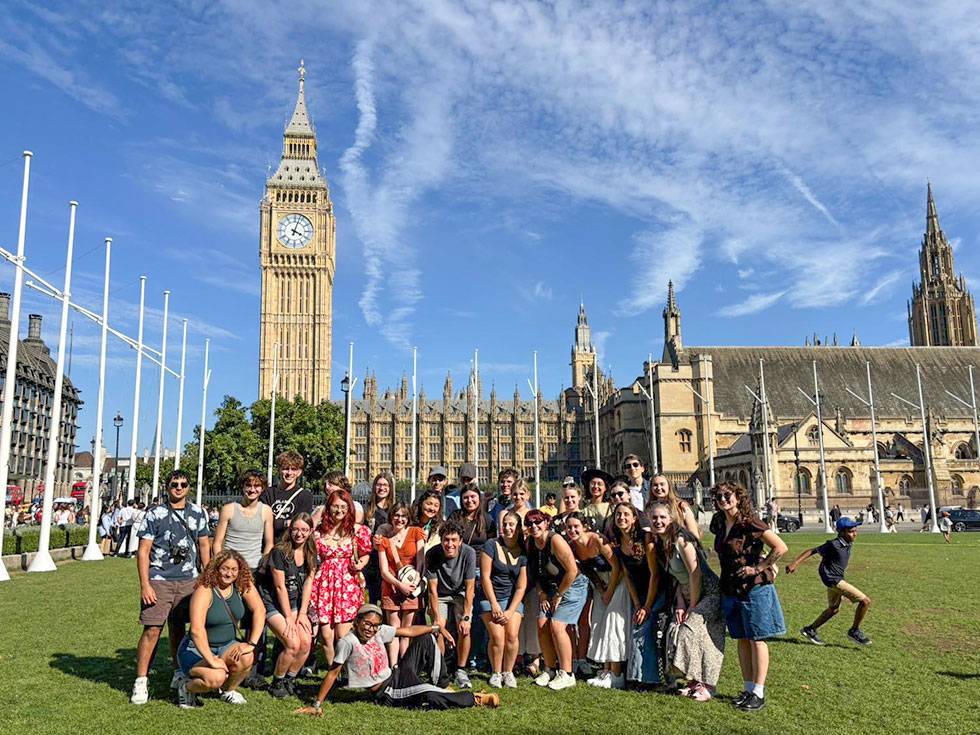 A group of students pose together with the Big Ben clock tower in the background. 