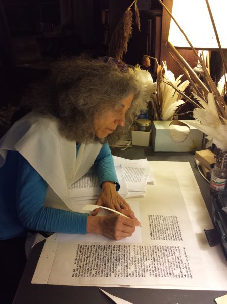 Linda Motzkin writing at desk