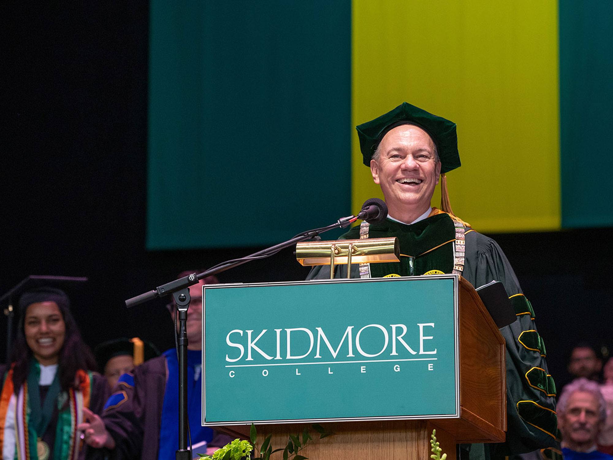 President Marc Conner at a Skidmore podium speaking at commencement