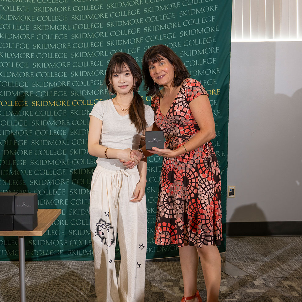 Student poses with Chloe Jaleel while accepting a Davis UWC Scholar award